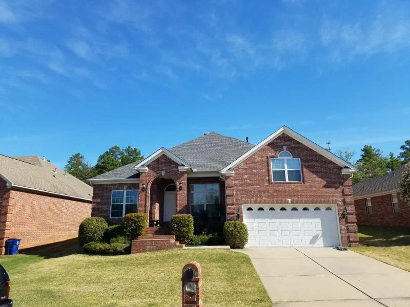 Brick home with a front gable and an attached garage from CAR’s residential portfolio
