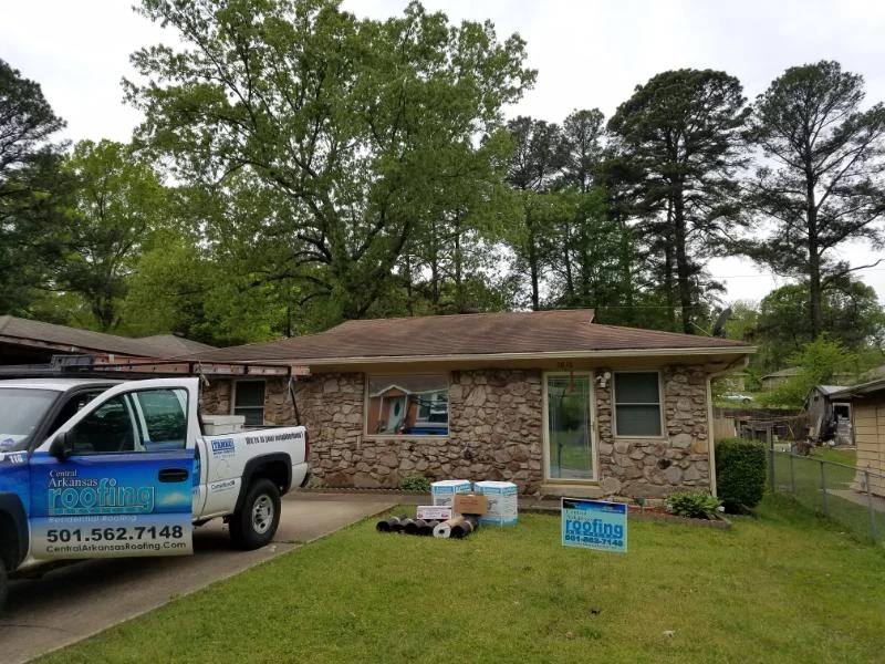 Stone-front home with a low shingle roof and CAR truck from CAR’s residential portfolio